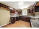 A kitchen featuring wood cabinets, granite countertops, and tile backsplash at 2703 Flagstone Se Dr, Atlanta, GA 30316
