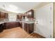 Functional kitchen with dark wood cabinets, granite countertops, and tiled backsplash at 2703 Flagstone Se Dr, Atlanta, GA 30316