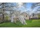 View of the back of the house featuring a wooden deck with white railings and a large grassy lawn at 3813 Nowlin Nw Rd, Kennesaw, GA 30144