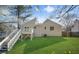 View of the back of the house featuring a wooden deck with white railings and a large grassy lawn at 3813 Nowlin Nw Rd, Kennesaw, GA 30144