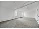 Spacious unfinished basement features carpet, white walls, and windows at 3813 Nowlin Nw Rd, Kennesaw, GA 30144