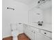 Bright bathroom features a modern sink, toilet, and wood-look flooring at 3813 Nowlin Nw Rd, Kennesaw, GA 30144