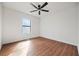 Sunlit bedroom featuring wood floors, a ceiling fan, and a window at 3813 Nowlin Nw Rd, Kennesaw, GA 30144