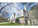 View of the home's exterior with its stone accents, mix of horizontal and vertical siding, and a beautifully landscaped front yard at 3813 Nowlin Nw Rd, Kennesaw, GA 30144