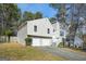 Charming two-story home with a two-car garage, complemented by a well-kept lawn and mature trees at 3813 Nowlin Nw Rd, Kennesaw, GA 30144