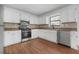 Bright kitchen featuring white cabinets and stainless steel appliances at 3813 Nowlin Nw Rd, Kennesaw, GA 30144