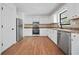 Well-lit kitchen with white cabinets and stainless steel appliances, providing a clean and modern cooking space at 3813 Nowlin Nw Rd, Kennesaw, GA 30144