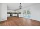 Bright kitchen featuring new flooring and white cabinetry, complemented by stainless steel appliances at 3813 Nowlin Nw Rd, Kennesaw, GA 30144