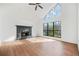 Bright living room featuring high ceilings, a striking stone fireplace, and large windows offering ample natural light at 3813 Nowlin Nw Rd, Kennesaw, GA 30144