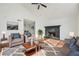 Cozy living room with a stone fireplace, comfortable seating, and stylish decor, creating an inviting atmosphere at 3813 Nowlin Nw Rd, Kennesaw, GA 30144