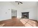 Open living room showcasing new floors and a stone fireplace, creating a welcoming and modern space at 3813 Nowlin Nw Rd, Kennesaw, GA 30144