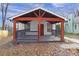 Charming home featuring a welcoming front porch, red beam accents and tidy landscaping at 391 S Bend Se Ave, Atlanta, GA 30315