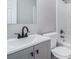 Bathroom with grey vanity, sleek black faucet, white toilet, and a shower-tub combination at 441 Village Way, Lawrenceville, GA 30046