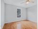 Bedroom with neutral walls, laminate floors, a ceiling fan, and a window overlooking the backyard at 441 Village Way, Lawrenceville, GA 30046