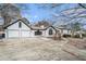 Charming home featuring an attached two-car garage, with a concrete driveway and mature landscaping at 441 Village Way, Lawrenceville, GA 30046