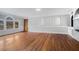 Bright living room featuring hardwood floors, neutral walls, built-in shelving, and a charming front door at 441 Village Way, Lawrenceville, GA 30046