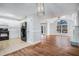 Open floor plan with kitchen and living room featuring hardwood floors and natural light at 441 Village Way, Lawrenceville, GA 30046