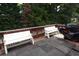 Enjoy the serene wooded views from this spacious back deck with two benches and a grill at 442 John Stewart Pl, Suwanee, GA 30024