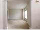 Spacious living room with neutral carpet and large windows providing plenty of light at 442 John Stewart Pl, Suwanee, GA 30024