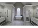 Bathroom featuring double vanities, a soaking tub under a stained glass window, and a stand-up shower at 7910 Tintern Trce, Duluth, GA 30097