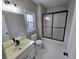 Bathroom featuring a shower/tub combo and vanity with black fixtures at 7910 Tintern Trce, Duluth, GA 30097