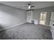 Neutral bedroom with carpet flooring, built-in shelving, and an ensuite bathroom at 7910 Tintern Trce, Duluth, GA 30097