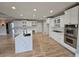 Bright kitchen with white cabinets, stainless steel appliances, a center island, and hardwood flooring at 7910 Tintern Trce, Duluth, GA 30097