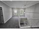 Spacious landing area with neutral carpet, white trim, and natural light from two windows at 7910 Tintern Trce, Duluth, GA 30097