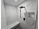 Modern shower featuring marble-patterned tile, bench seat, rain shower head, and recessed niche at 7910 Tintern Trce, Duluth, GA 30097