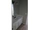Bathroom with a vanity sink and a framed mirror at 1947 Kensington High Sw St, Lilburn, GA 30047