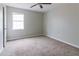 Bright bedroom features a large window, ceiling fan, and carpet flooring at 2172 Red Rose Ln, Loganville, GA 30052