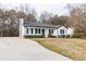 Inviting home with an expansive driveway, black shutters, and mature landscaping at 2172 Red Rose Ln, Loganville, GA 30052