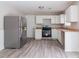 Well-equipped kitchen with stainless steel appliances, granite countertops, and white cabinets at 2172 Red Rose Ln, Loganville, GA 30052