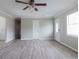Spacious living room featuring gray laminate flooring, gray walls, and a ceiling fan at 2172 Red Rose Ln, Loganville, GA 30052