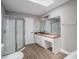 Bright bathroom featuring a walk-in shower, vanity area with a built-in seat and hardwood floors at 336 Rockmoor Trl, Marietta, GA 30066
