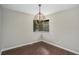 Cozy dining room featuring hardwood floors, a modern chandelier, and a sunlit window at 336 Rockmoor Trl, Marietta, GA 30066