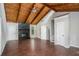 Spacious living room boasts vaulted ceilings, wood beams, hardwood floors, and a cozy stone fireplace at 336 Rockmoor Trl, Marietta, GA 30066