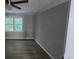Bedroom featuring a window view, neutral paint, and a ceiling fan with decorative light fixture at 409 Arbor Ridge Dr, Stone Mountain, GA 30087