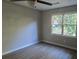 Bright bedroom with hardwood floors and a ceiling fan with a decorative light fixture at 409 Arbor Ridge Dr, Stone Mountain, GA 30087