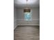Dining room featuring gray walls, white trim, wood-look flooring, and a stylish light fixture at 409 Arbor Ridge Dr, Stone Mountain, GA 30087