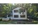 Two-story home featuring dark shutters and situated on a landscaped lot shaded by mature trees at 409 Arbor Ridge Dr, Stone Mountain, GA 30087