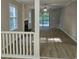 Living room with gray walls, white trim, wood-look floors, and access to the back deck at 409 Arbor Ridge Dr, Stone Mountain, GA 30087