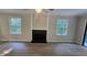 Living room with a gray color palette, black fireplace, and an abundance of natural light at 409 Arbor Ridge Dr, Stone Mountain, GA 30087
