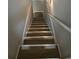 Interior view of carpeted stairs with white risers and a white hand rail at 409 Arbor Ridge Dr, Stone Mountain, GA 30087