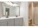 Bathroom featuring double vanity, tile floors, large mirror, and a walk-in shower at 4902 Cedar Se Ct, Conyers, GA 30094