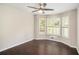 Bedroom with large windows with shutters, hardwood floors, and a ceiling fan at 4902 Cedar Se Ct, Conyers, GA 30094