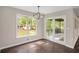 Cozy dining area featuring hardwood floors, modern light fixture, and natural light from large window at 4902 Cedar Se Ct, Conyers, GA 30094