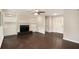 Spacious living room with a fireplace, built-in shelves, and beautiful hardwood floors at 4902 Cedar Se Ct, Conyers, GA 30094