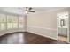 Main bedroom featuring a bay window, hardwood floors, ceiling fan and en-suite bathroom at 4902 Cedar Se Ct, Conyers, GA 30094
