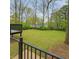 Expansive backyard with lush lawn and mature trees offer a private outdoor space at 1691 Flat Shoals Rd, Atlanta, GA 30316